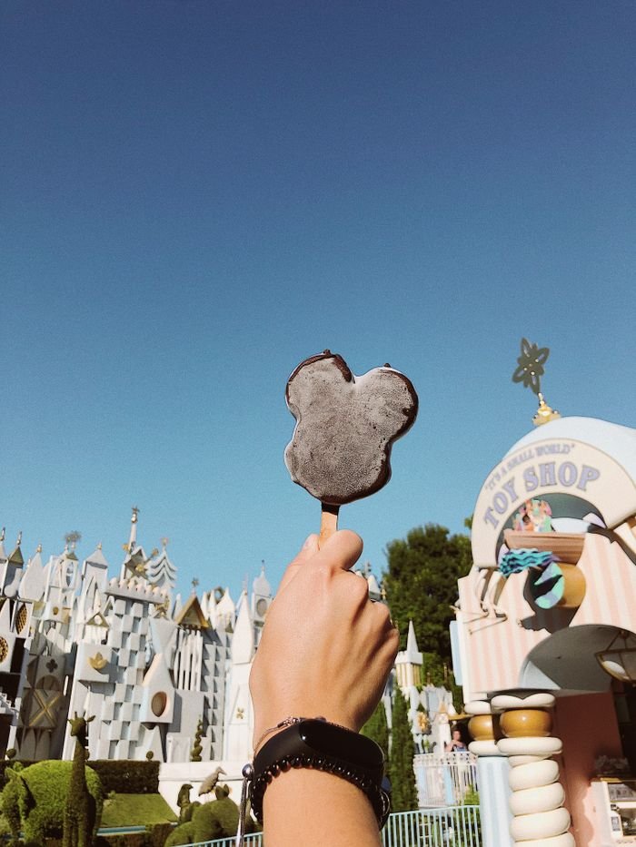 Enjoy a sunny day at Disneyland Anaheim with a tasty Mickey ice cream in hand.